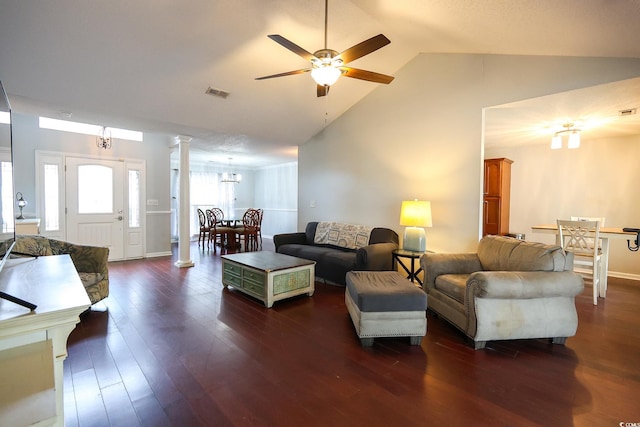 living room with dark hardwood / wood-style flooring, lofted ceiling, ceiling fan, and ornate columns