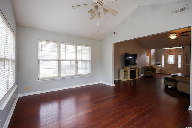 living room with lofted ceiling, dark hardwood / wood-style floors, a wealth of natural light, and ceiling fan