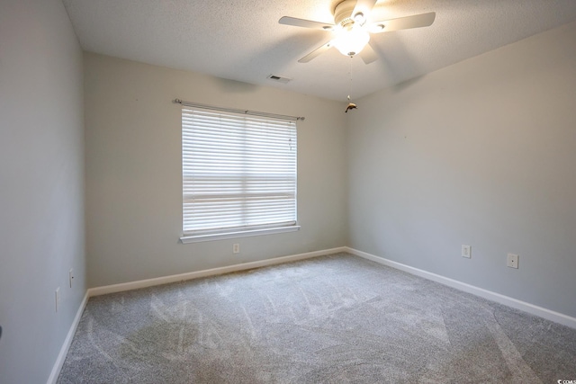 carpeted empty room featuring a textured ceiling and ceiling fan