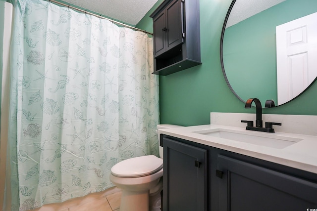 bathroom featuring vanity, tile patterned floors, toilet, and a textured ceiling