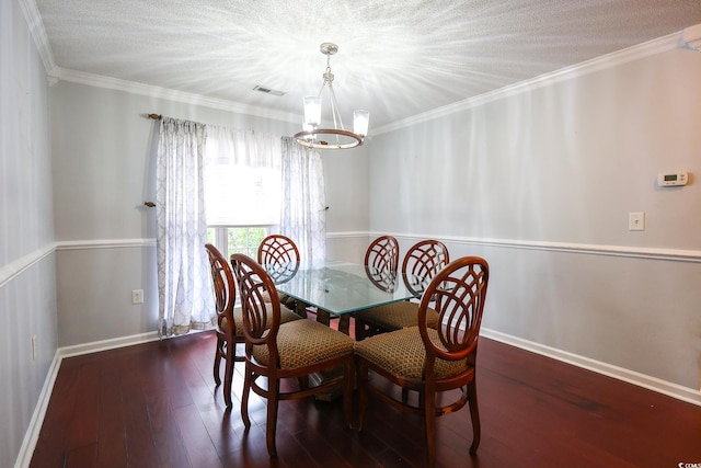 dining room with ornamental molding, an inviting chandelier, and dark hardwood / wood-style flooring