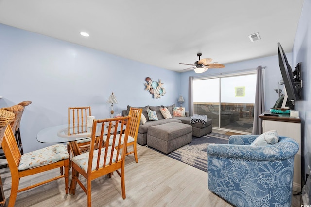 living room featuring ceiling fan and light wood-type flooring