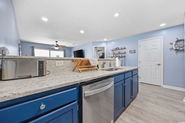 kitchen with blue cabinets, dishwasher, sink, and light hardwood / wood-style flooring