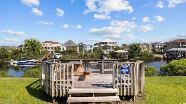 wooden terrace with a lawn and a water view