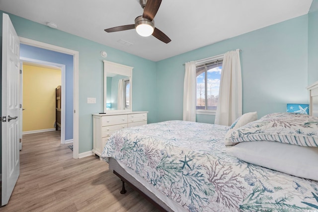 bedroom with ceiling fan and light hardwood / wood-style floors