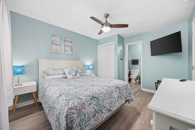 bedroom featuring hardwood / wood-style flooring, ceiling fan, connected bathroom, and a closet