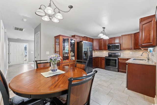 dining room with sink and an inviting chandelier