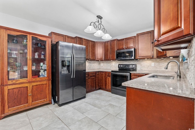 4821 Southgate Pkwy, Myrtle Beach, SC 29579 - kitchen featuring stainless steel appliances, a sink, light stone countertops, decorative backsplash, and hanging light fixtures