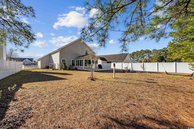 rear view of house featuring a sunroom