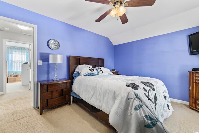 bedroom with lofted ceiling, light colored carpet, and ceiling fan