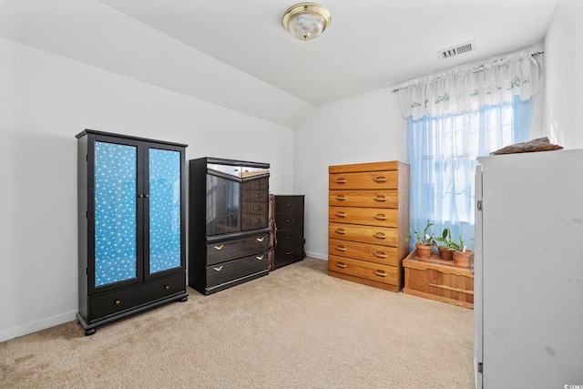 bedroom with lofted ceiling and light carpet