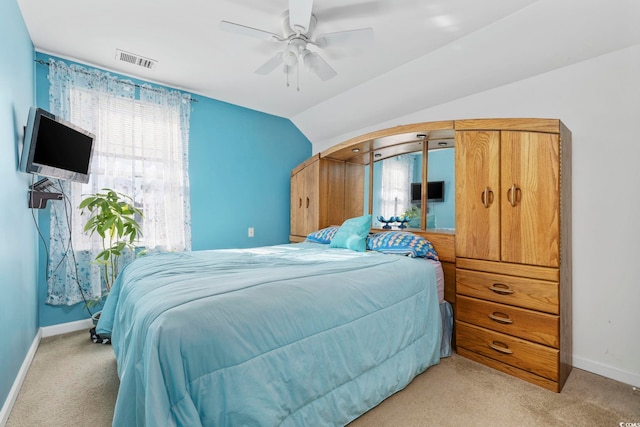 bedroom with lofted ceiling, light colored carpet, and ceiling fan