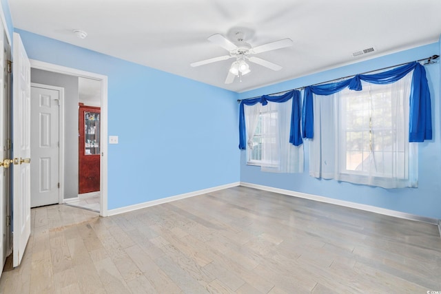 spare room with ceiling fan and light hardwood / wood-style floors