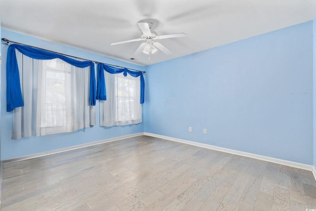 empty room featuring ceiling fan and light hardwood / wood-style floors