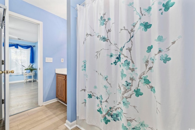 bathroom featuring hardwood / wood-style flooring and vanity