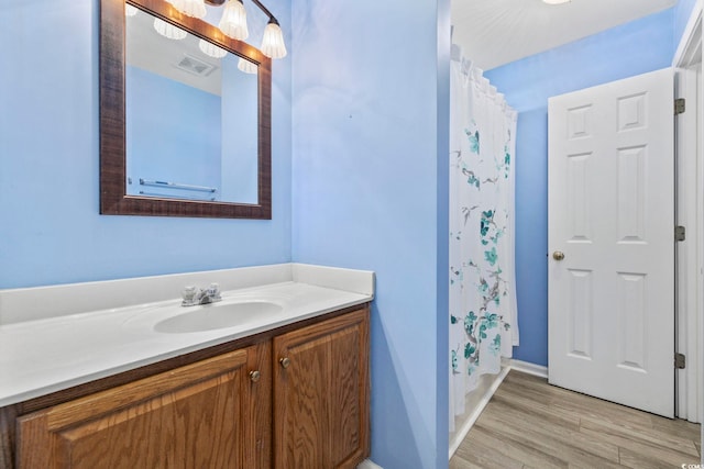 bathroom featuring vanity, hardwood / wood-style flooring, and a shower with curtain