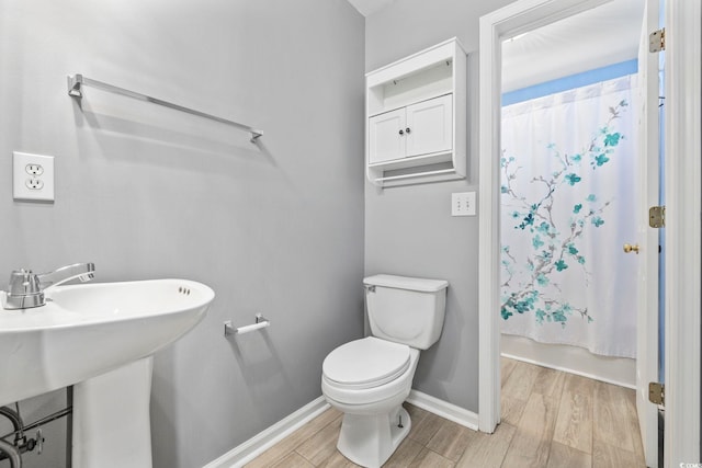 4821 Southgate Pkwy, Myrtle Beach, SC 29579 - bathroom featuring wood finished floors, toilet, baseboards, and shower / bath combination with curtain