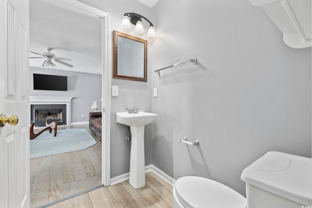 bathroom featuring ceiling fan and toilet