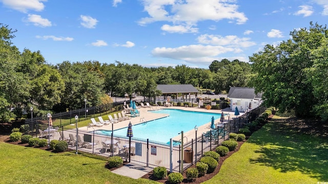 view of pool with a yard and a patio