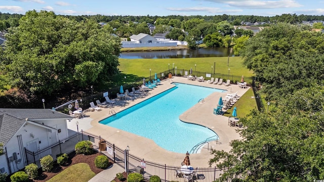 view of swimming pool with a water view, a yard, and a patio