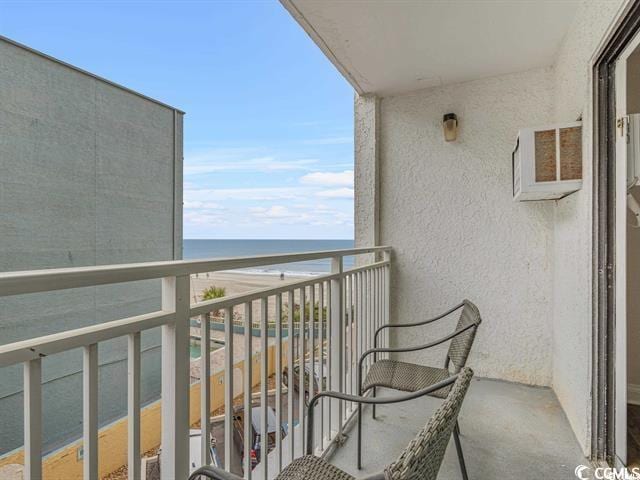 balcony featuring a water view and a view of the beach