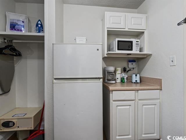 1205 S Ocean Blvd Unit 50412, Myrtle Beach, SC 29577 - kitchen with white appliances, white cabinets, open shelves, and light countertops