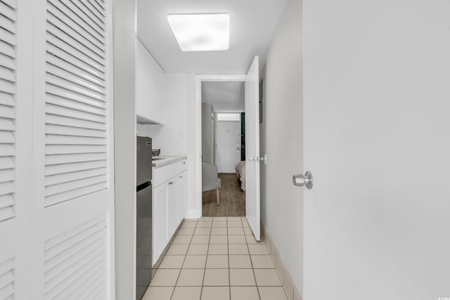 corridor with light tile patterned floors