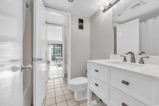 bathroom featuring a shower with curtain, tile patterned floors, toilet, and vanity