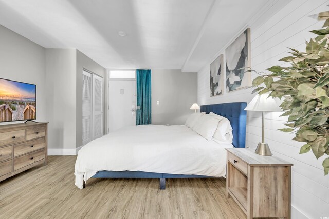 bedroom with hardwood / wood-style floors and a closet