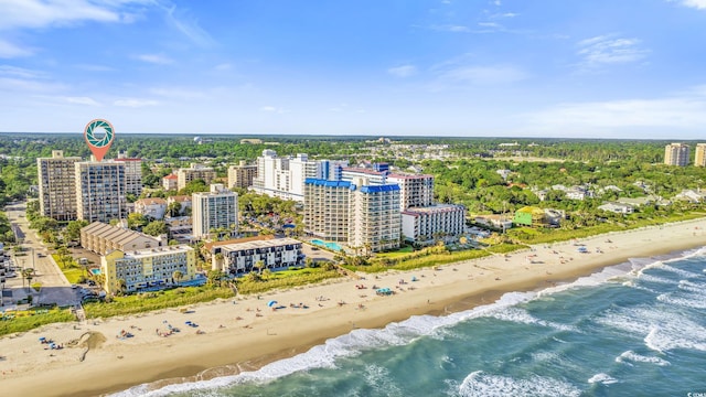 birds eye view of property with a water view and a beach view