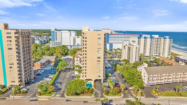 drone / aerial view with a water view and a beach view