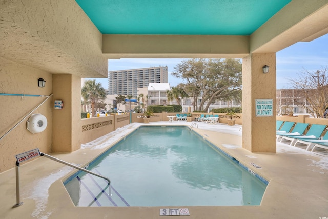 view of building exterior with a water view and a beach view