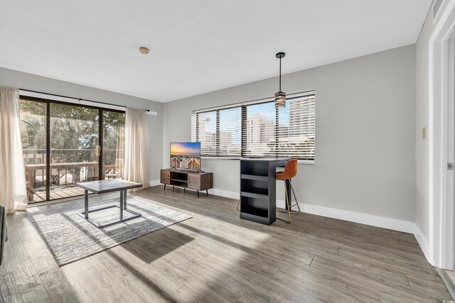 living room featuring hardwood / wood-style flooring and wood walls