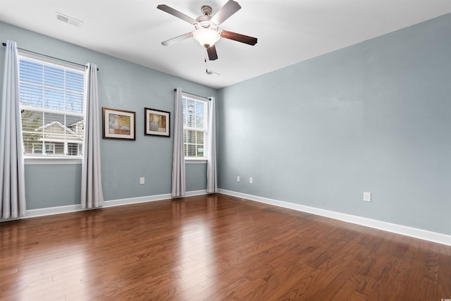 empty room with ceiling fan and dark hardwood / wood-style floors