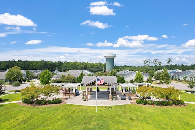 surrounding community featuring a lawn and a pergola