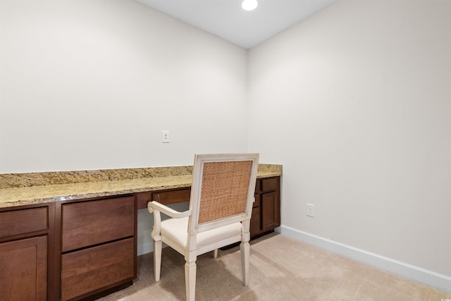 office area featuring built in desk and light colored carpet