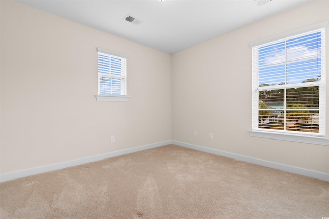 spare room with light colored carpet