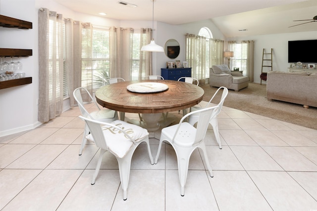 tiled dining room with vaulted ceiling and ceiling fan