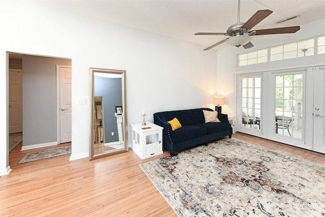 living room with ceiling fan and light wood-type flooring