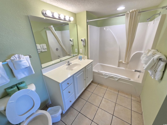 full bathroom featuring vanity, toilet, shower / bathtub combination with curtain, tile patterned floors, and a textured ceiling