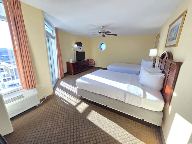 bedroom featuring ceiling fan, a wall mounted AC, carpet, and multiple windows