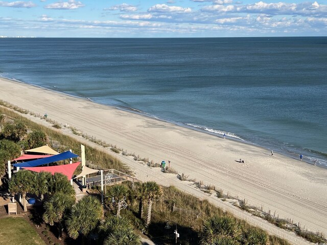 drone / aerial view featuring a water view and a view of the beach