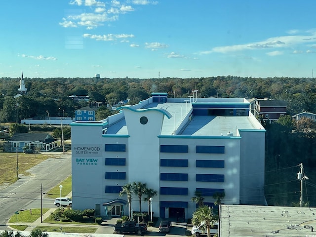 view of building exterior with a view of trees