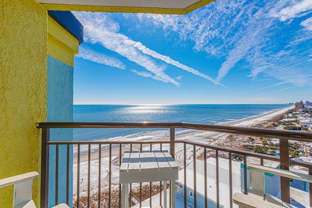 balcony featuring a view of the beach and a water view