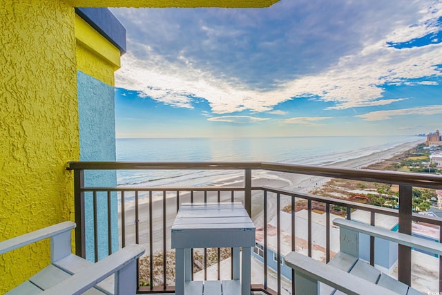 balcony with a water view and a beach view