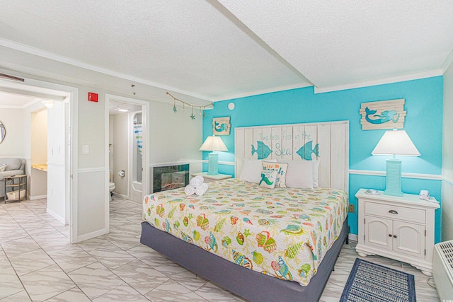 bedroom with ornamental molding and a textured ceiling