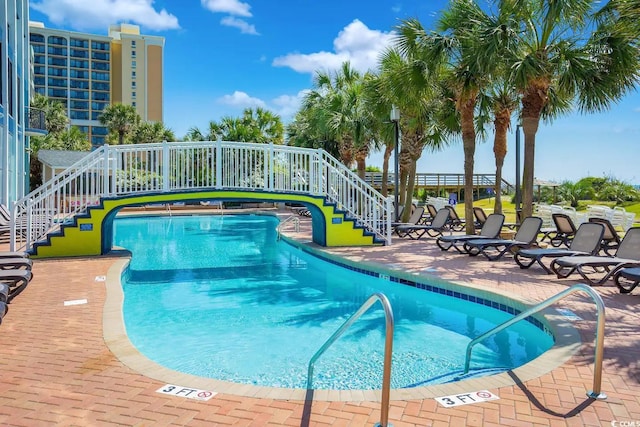 view of swimming pool with a patio