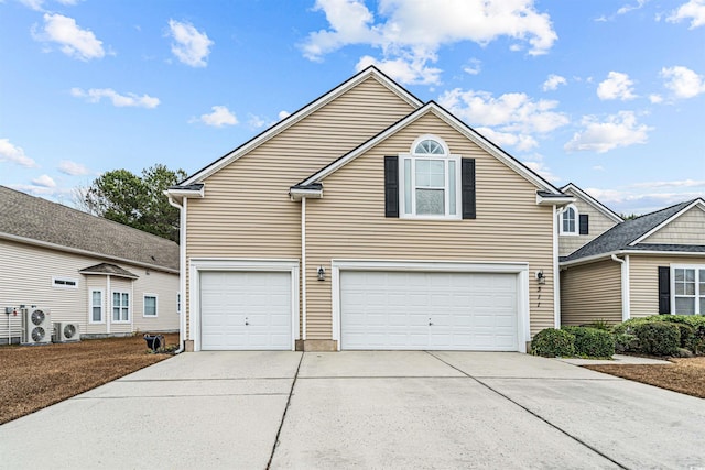 front facade with a garage and ac unit