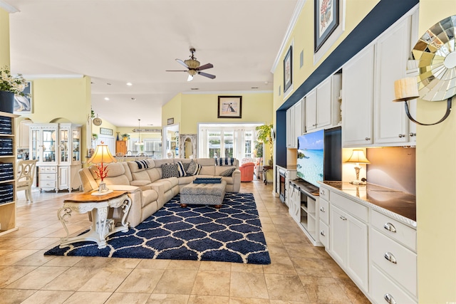 tiled living room featuring crown molding and ceiling fan