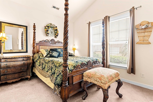 carpeted bedroom with lofted ceiling